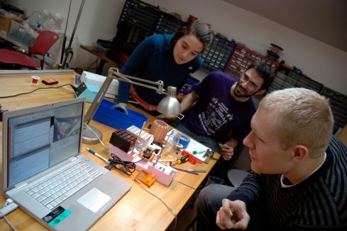 ucam-in focus2 Shaunalynn Duffy, Alec Resnick, and David Thompson lean closer as the ucam's image comes into focus. The camera cost $10 and took 5 minutes to hack.